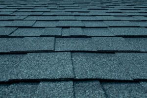 Close-up of asphalt roof shingles, durable roofing materials for residential or commercial roofing services.